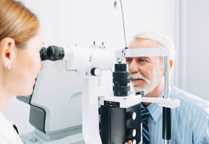 Senior man examined by an ophthalmologist, eye exam, eye exam Springfield MA, eye exam Western MA, optometrist Western MA, eye doctor East Longmeadow MA